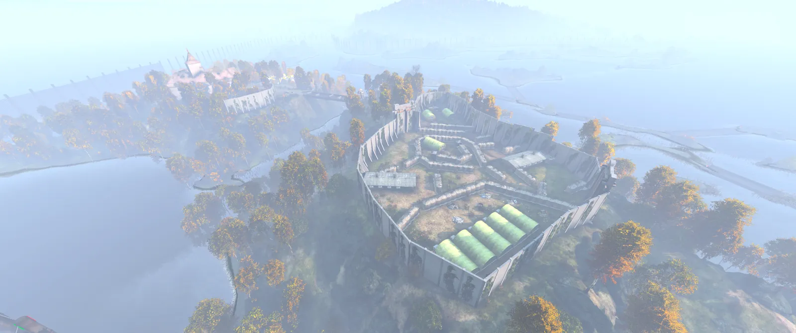 An overhead view of Prison Island, a walled fort with green hangars surrounded by misty water